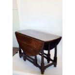 An 18th century oak drop-leaf table on bobbin turned legs and stretchers. 46ins wide.