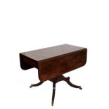 A Regency mahogany breakfast table with two drop leaves and frieze drawer with boxwood and ebony
