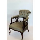 A Victorian walnut armchair with shell and acanthus leaf carved cresting rail, over-stuffed button