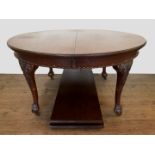 A Victorian mahogany extending dining table with gadrooned frieze, on scroll and acanthus leaf