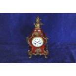 An early 20th century French ormolu and tortoise shell cased mantel clock with stylised floral and