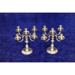 A pair of Elizabeth II silver five branch candelabra with detachable sconces, on tapering stems