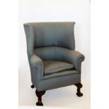 A Victorian porter's chair upholstered in a blue and cream silk material with high curved back,