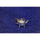 A George V silver teapot with ebony handle and finial and raised on four pad feet. Sheffield 1918.