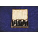 A set of six George V silver coffee spoons with black coffee bean form handles together with a