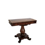 A Victorian rosewood fold-over top tea table with pierced scrolled carved frieze on a bulbous