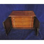 A Victorian mahogany collectors cabinet with twin panelled doors opening to reveal eight interior