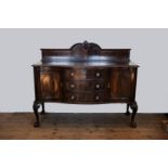 An Edwardian mahogany sideboard with scroll and acanthus leaf carved splashback, gadrooned rim above
