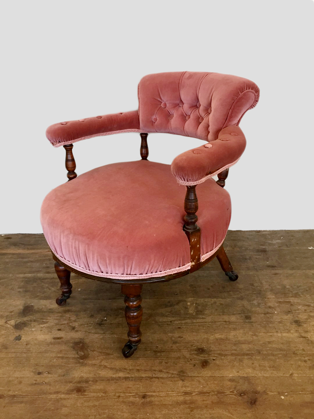 An Edwardian walnut bedroom chair with puce upholstered button back, on turned supports with over-