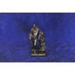 A bronze figure of Sir Walter Scott leaning against a tartan clad tree stump, with oak leaf and