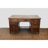 An Edwardian mahogany desk with tooled leather inset top, three frieze drawers and with three