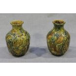 A pair of Doulton Lambeth stoneware pottery vases of ovoid form with olive and brown glazes and