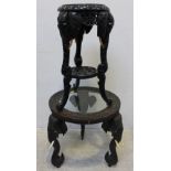 A 19th century carved hardwood glass-top circular occasional table, the three supports carved as