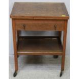 A stained oak "silver table" with baize-lined cutlery drawer above an under-tier, raised on castors.