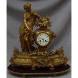 A 19th century gilded spelter French mantel clock, with eight-day movement striking a bell, white