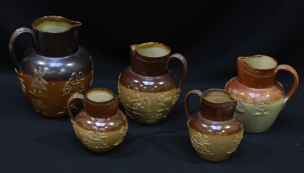 Five graduated Doulton salt-glazed stoneware harvest jugs, comprising one large, two medium and