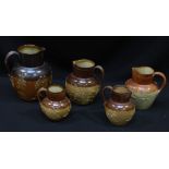 Five graduated Doulton salt-glazed stoneware harvest jugs, comprising one large, two medium and