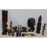 A pair of teak elephant bookends and various other carvings including two native daggers, (16).