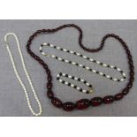 A string of Bakelite beads, a row of freshwater pearls, and a necklace and matching bracelet of