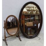 A 1930s oval stained wood hanging wall mirror, together with an early 20th century oval toilet