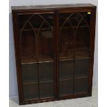 A 19th century mahogany glazed bookcase top, with a pair of Gothic tracery doors enclosing