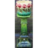 A Bretby pottery jardinière stand in the Renaissance revival style, shape 1086, with green lead-