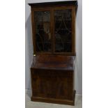 A mahogany bureau bookcase, moulded cornice above a diamond parquetry frieze, a pair of oval