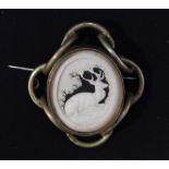 A Victorian yellow metal oval double glass brooch, one side set with an ivory-carved pierced panel