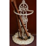 A Victorian cast iron and white painted umbrella and stick stand, and five walking sticks.