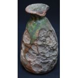 An antique Near-Eastern pottery bottle vase, of ovoid form and with traces of original green lead