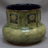 A Royal Doulton Art Nouveau design stoneware jardinière with mottled green and grey glaze, decorated