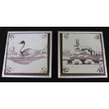 A pair of 18th century Dutch Delft tiles, painted with a swan and a hare, with ships in the