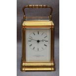 A 19th century brass carriage clock, with eight-day movement striking a bell, White enamel dial with