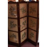 An Edwardian stained walnut three-fold dressing screen, one side with velvet panels, the opposing