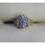 An 18ct gold diamond cluster ring claw set with seven diamonds approx. weight a total of 0.94cts,