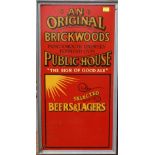 A framed Brickwoods Brewery advertising sign of rectangular form, hardboard with gold lettering to a