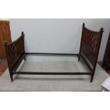 An Edwardian mahogany double bedstead, with square stiles and spindled gallery, bowed top rail and