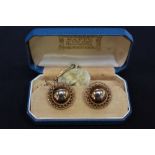 A pair of 9ct gold earrings, of half spherical form with pierced rims, post and butterfly-clip