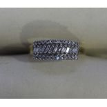 A 9ct gold three row ring claw set with twenty four round brilliant cut diamonds to the outer rows