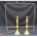 A brass spark guard, together with a pair of brass candlesticks and a brass-topped cane.  (3)