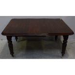 A 19th century mahogany extending dining table, with one extra leaf, moulded edge to top, raised