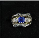 An antique sapphire and diamond dress ring, centrally claw-set with a cornflower blue cushion-cut