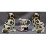 A pair of 19th century Staffordshire Pottery models of seated spaniels, decorated with copper luster