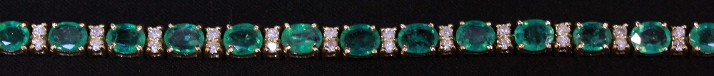 An 18ct claw set emerald and diamond line bracelet approx. weight 12.3grms.