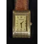 A Boucheron ladies 18ct gold wristwatch, AG 12874 on leather strap, with sliding bar catch.