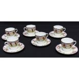 A set of six Royal Doulton cups and saucers, number H2586, decorated with trees against a setting