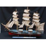 A large scratch built model ship the 'Cutty Sark', with realistic rigging and mounted on a wooden