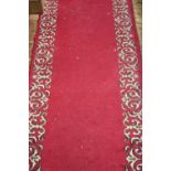 A hand-knotted woollen Caucasian long hall runner, scarlet ground with cream stylized arabesque