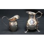 A Regency silver cream jug, c.1830s, with engraved flowers, scrolled handle and shell feet; together