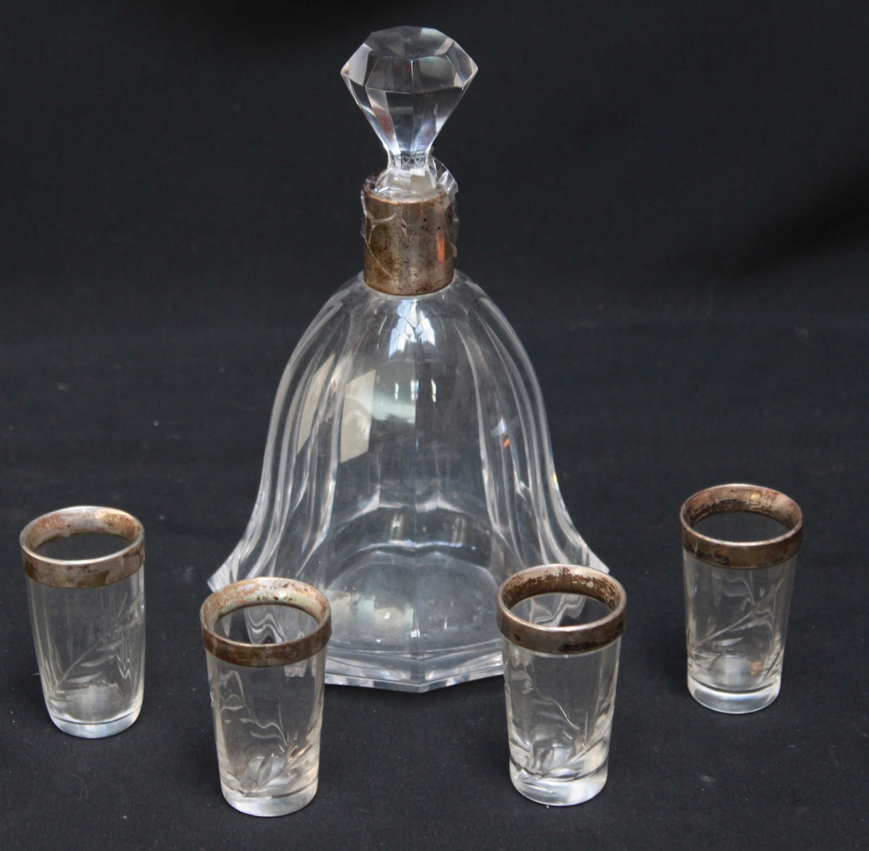 A Continental silver and cut glass liqueur set, comprising a decanter and four small glasses, all